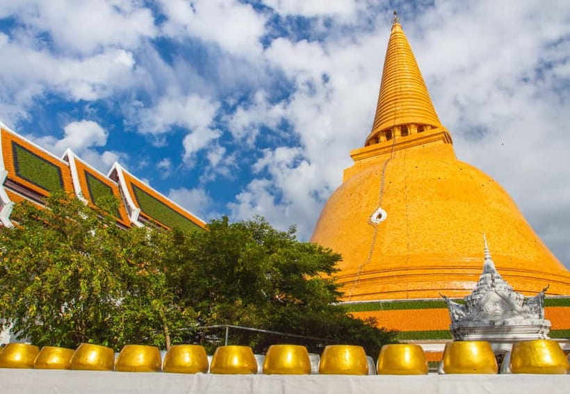 Bangkok: Floating Market, Phra Pathom Pagoda & Cafes Tour - Maeklong Railway Market: food stalls with a train timetable