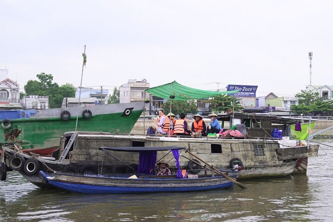 Can Tho Floating Market and Fruit Garden Tour - A traditional wooden boat and a small group