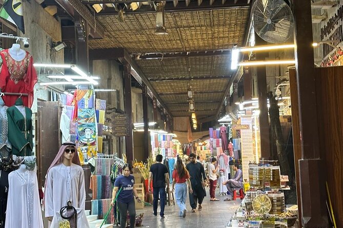 Dubai Old Town Walking Tour with Abra ride, Spice and Gold Souk - Textile Souk: color, bargaining, and salesmanship