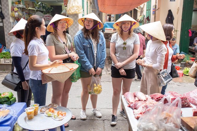 Hanoi Maya Kitchen: Traditional Cooking Class & Market Tour - Rolling fried spring rolls by hand