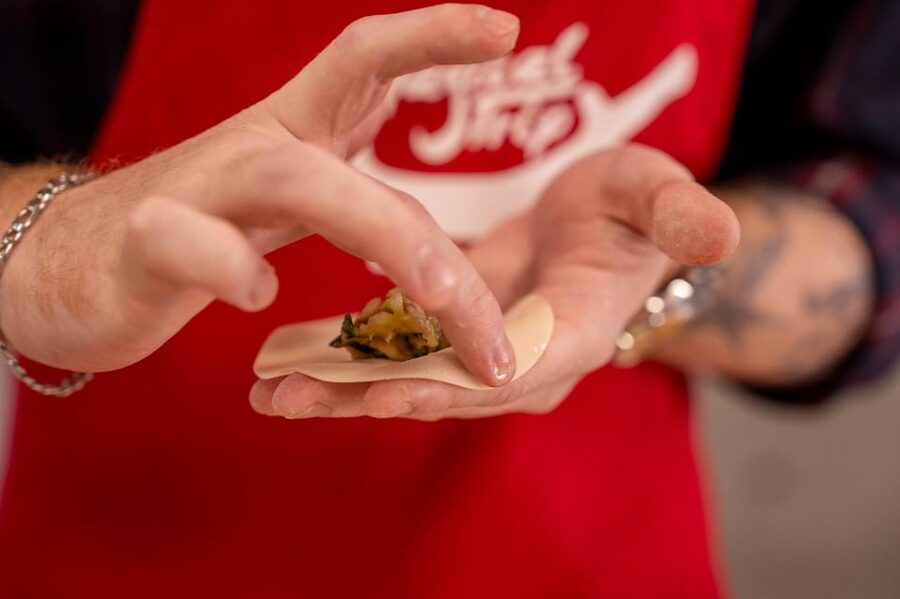 Osaka: Cooking Class & Sake Tasting with Local Market Visit - Folding Gyoza Turns Cooking Into a Group Activity
