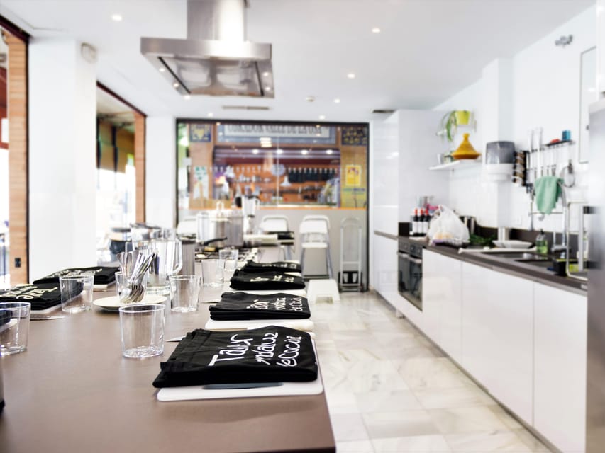 Seville: 3.5-Hour Spanish Cooking Class & Triana Market Tour - Inside the cooking school at stalls 75 to 77